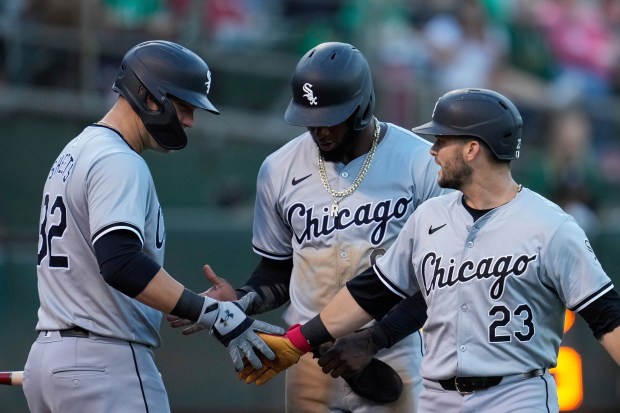 White Sox left fielder Andrew Benintendi, right, celebrates with Gavin Sheets, left, after hitting a two-run home run against the Athletics during the fourth inning on Aug. 6, 2024, in Oakland, Calif. (Godofredo A. Vásquez/AP)