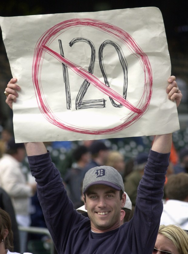 Jeff Washburn holds up a sign after the Detroit Tigers beat the Minnesota Twins 9-4 in Detroit, Sunday, Sept. 28, 2003. The Tigers avoided matching the post-1900 record of 120 losses in a season, set by the 1962 New York Mets. The Tigers entered their final game of the season against the AL Central champion Twins with 119 losses. (AP Photo/Paul Sancya)