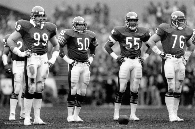 With a defiant hands-on-hips posture, Bear defenders Dan Hampton , from left, Mike Singletary, Otis Wilson and Steve McMichael wait for more action against the Redskins in 1984. Chicago Tribune photo by Bob Langer published December 31, 1984Date Created: 1984-12-30 Copyright Notice: Chicago Tribune Folder Description: Chicago Bears Folder Extended Description: Football Team 1984 Title: CHICAGO BEARS 1984 Subject: CHICAGO BEARS