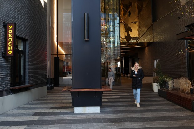 People walk on the The Mews Pedway at 167 N. Green Street in the Fulton Market district on Dec. 20, 2023. (Eileen T. Meslar/Chicago Tribune)