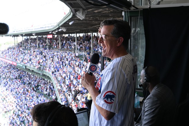 Stephen Colbert sings "Take Me Out to the Ballgame" in the announcers booth during the Toronto Blue Jays vs Chicago Cubs game at Wrigley Field on Aug. 17, 2024 in Chicago. (Scott Kowalchyk/CBS)