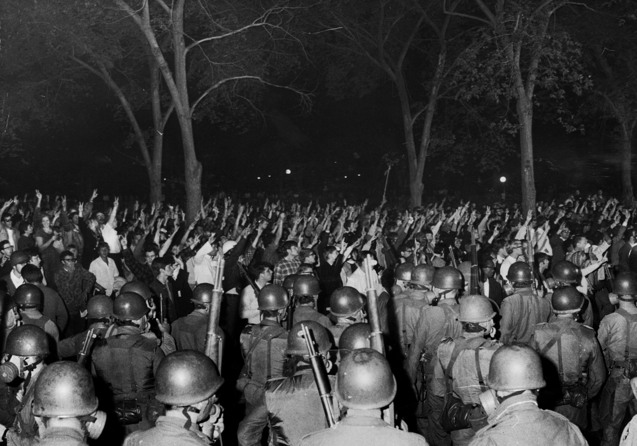 Anti-war protesters gather in Grant Park surrounded by police during...