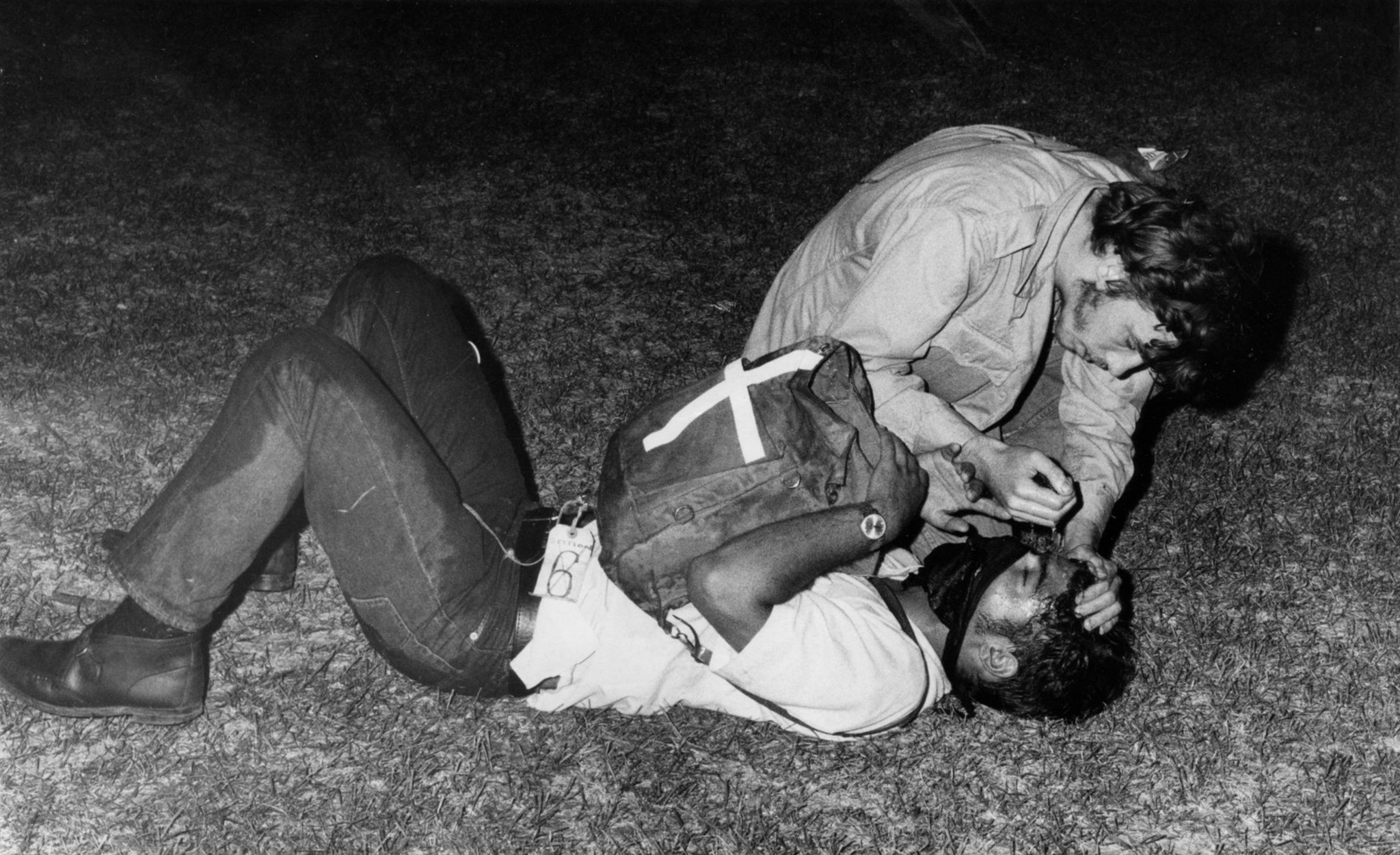 An injured protester gets aid after being tear-gassed during the...