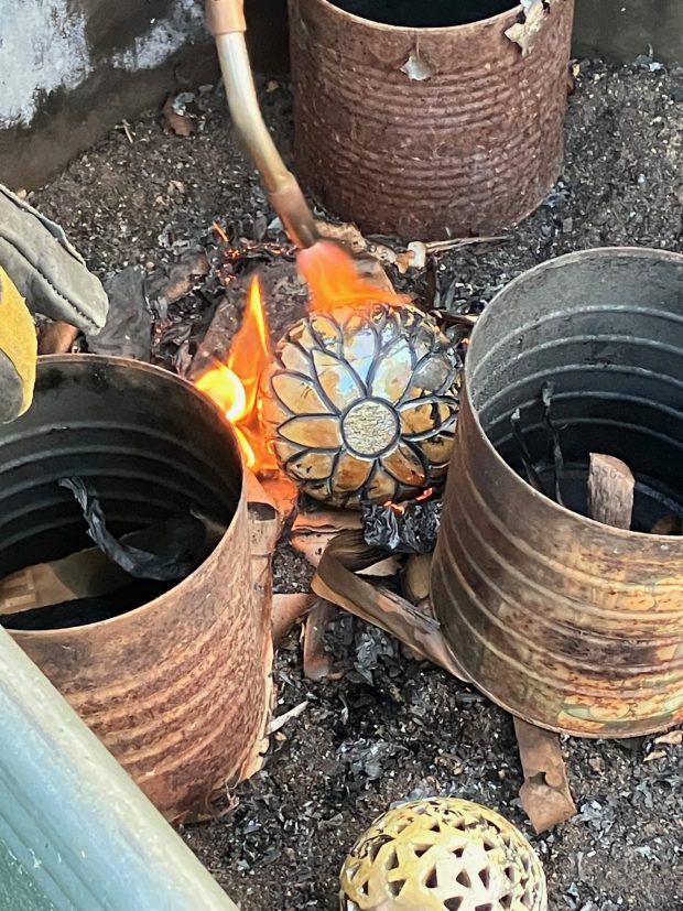 Ceramic orbs hand-carved and painted by artists at Fine Line Creative Arts Center in St. Charles are fired in a kiln. Participants in the Great Orb Hunt in Kane County forest preserves, including one in Elgin, will be looking for them as well as handblown glass ornaments. (Fine Line Creative Arts Center)