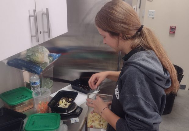 Randall Oaks Zoo intern Holly Gilchrist in the animal commissary in the new World of Wonders building prepares a mix of food Thursday that will be fed to a skunk, one of the animals that make up the West Dundee zoo's menagerie. (Mike Danahey/The Courier-News)