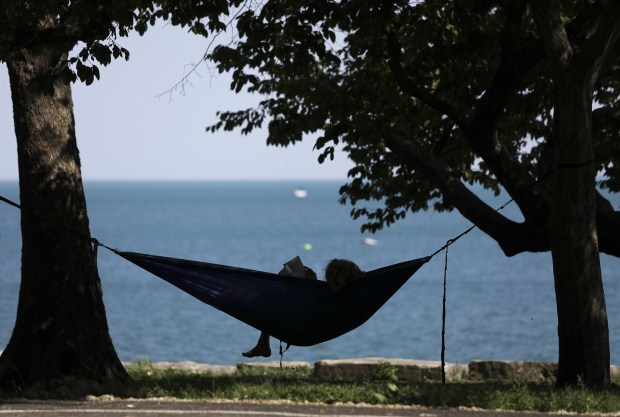 A young man reads a book along the lakefront at Promontory Point on June 4, 2021. (Abel Uribe / Chicago Tribune)