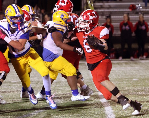 Marist's John McAuliffe (6) tries to turn the corner against De La Salle during a CCL/ESCC crossover game in Chicago on Friday, Oct. 6, 2023.