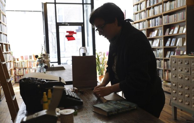 Katharine Solheim, co-owner of Pilsen Community Books, prepares books for a customer on April 16, 2020. (Abel Uribe/Chicago Tribune)