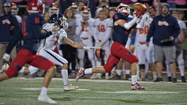 West Aurora's Logan Mont cradles in a pass on a play that went for a 70-yard touchdown during a game on Friday, Oct. 4, 2019.