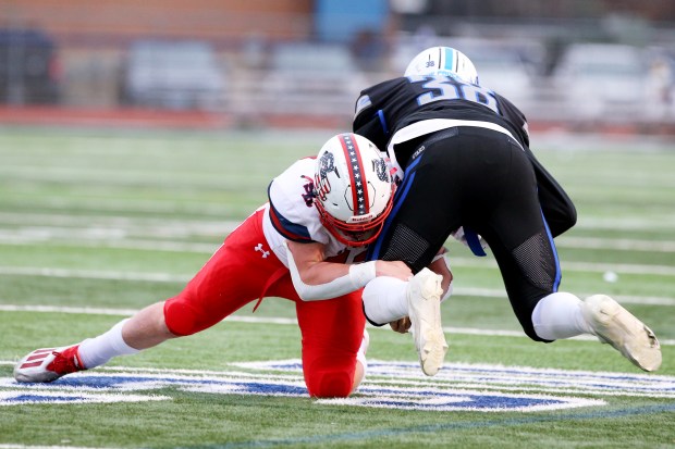 St. Rita's James Kingsbury finishes off a tackle against St. Charles North's Joell Holloman (38) during a Class 7A state quarterfinal in St. Charles on Nov. 12, 2022.