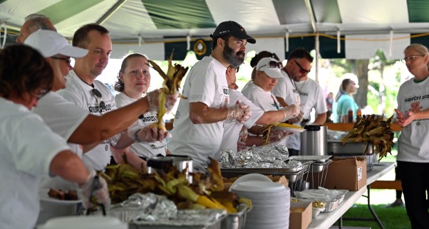 Fifth from left, volunteering in a food tent with Woodland School District 50 colleagues is Tim Sheldon, principal at Woodland Intermediate School in Gurnee at Gurnee Days on Aug. 10, 2024. (Karie Angell Luc/Lake County News-Sun)