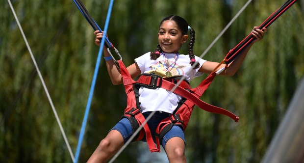 On the aerial jumping activity is Karina Jenkins, 9, a rising fourth-grader from Gurnee at Gurnee Days on Aug. 10, 2024. (Karie Angell Luc/Lake County News-Sun)