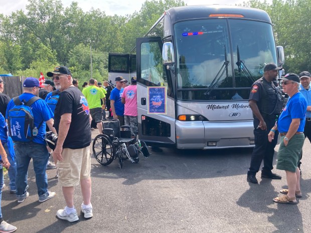 Veterans and their guardians board the bus to begin their journey on Lake County Honor Flight 25. (Steve Sadin/For the Lake County News-Sun)