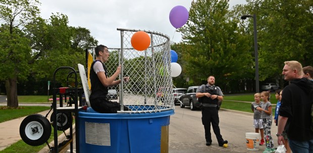 Michael Bryant of Highland Park, who plays quarterback for the Highland Park High School Giants football team, is dunked in the dunk tank at National Night Out on Aug. 6, 2024 at Highland Park City Hall (1707 St. Johns Ave.). (Karie Angell Luc/Lake County News-Sun)