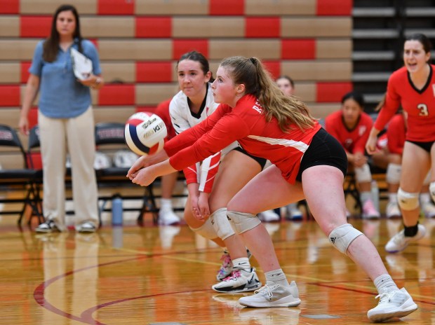 Naperville Central's Caroline Impey digs out a Plainfield North serve as libero Kate Torti backs her up during a game against Plainfield North on Wednesday, Aug. 28, 2024 in Plainfield...(Jon Cunningham/for The Naperville Sun)