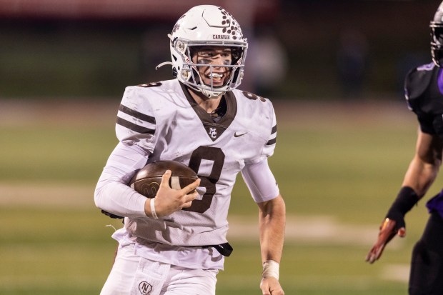 Mount Carmel's Jack Elliott (9) finishes off a touchdown run against Downers Grove North in the Class 7A state championship game at Illinois State University's Hancock Stadium in Normal on Saturday, Nov. 25, 2023.