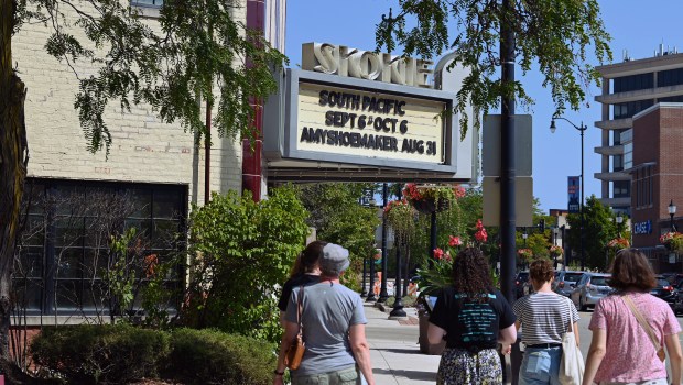 The tour group heads in the direction of the Skokie Theatre on Lincoln Avenue during the Historic Downtown Skokie Walking Tour on Aug. 25, 2024 in downtown Skokie. (Karie Angell Luc/Pioneer Press)