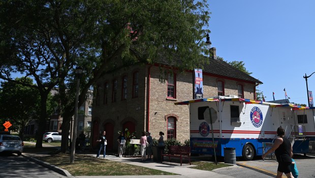 The tour group is assembled at the start point on Floral Avenue in front of the Skokie Heritage Museum during the Historic Downtown Skokie Walking Tour on Aug. 25, 2024 in downtown Skokie. (Karie Angell Luc/Pioneer Press)