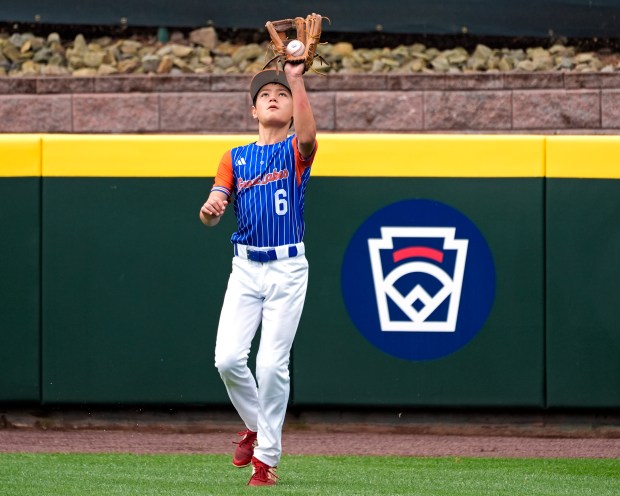 Hinsdale, Ill. right fielder Michael Kipnis (6) catches a ball hit by Staten Island, N.Y.'s Vincent Ruggiero during the first inning of a baseball game at the Little League World Series tournament in South Williamsport, Pa., Sunday, Aug. 18, 2024. (AP Photo/Tom E. Puskar)