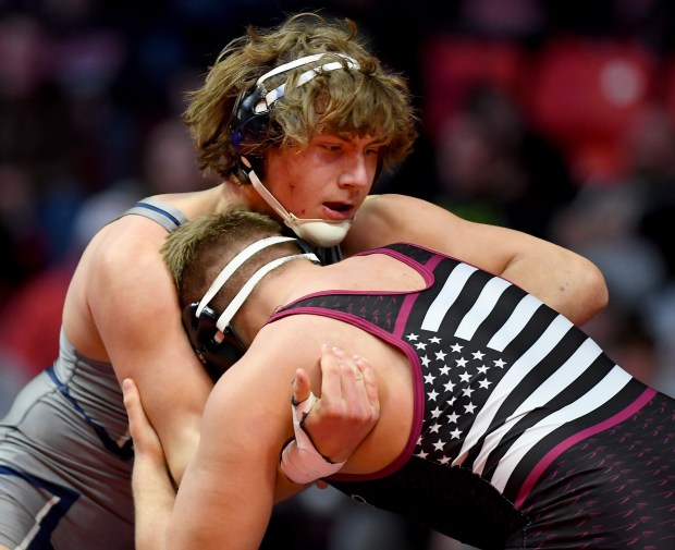 Nazareth's Gabe Kaminski, top, wrestles against Dakota's Noah Wenzel during the Class 1A state championship match at 220 pounds at the State Farm Center in Champaign on Saturday, Feb. 18, 2023. Wenzel won by a 2-1 decision. (Rob Dicker / Pioneer Press)