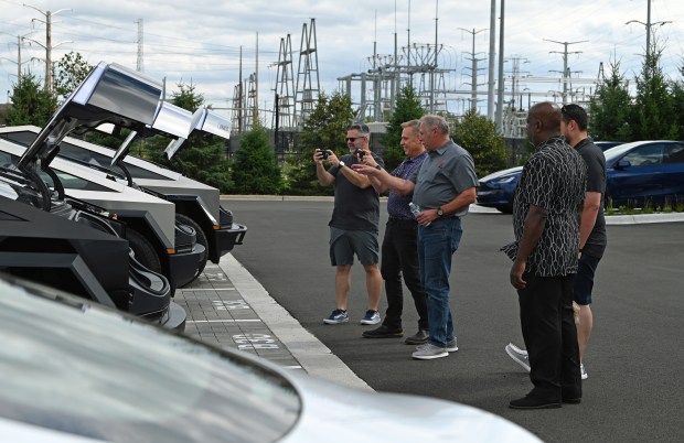 People check out Tesla products at the official grand opening of the Northbrook Tesla on Aug. 9, 2024 in Northbrook. (Karie Angell Luc/Pioneer Press)