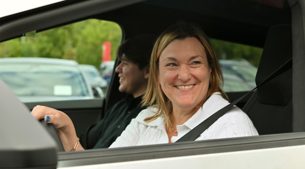 Northbrook Village President Kathryn L. Ciesla test drives a Tesla Cybertruck at the grand opening of the Northbrook Tesla on Aug. 9, 2024 in Northbrook (Karie Angell Luc/Pioneer Press)