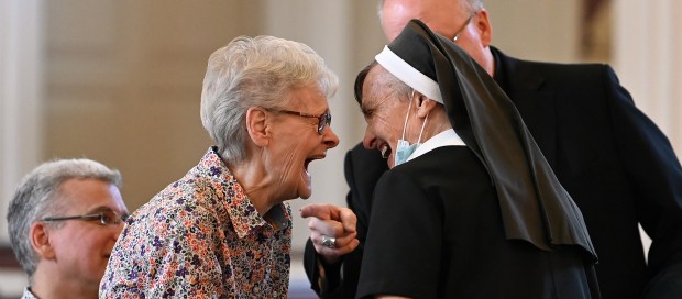 From left, Bonnie Grob of Elmwood Park, Bishop Jeffrey Grob's mother, greets Sister Paulanne Held of Glenview before the special mass and before the dedication and blessing of the church bells and clock tower on Aug. 11, 2024 at (OLPH) Our Lady of Perpetual Help Catholic Church in Glenview (1775 Grove St.). (Karie Angell Luc/Pioneer Press)