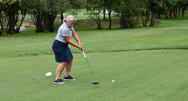 Winnetka Park District Board of Commissioners President Christina Codo is about to hit the ball at tee off after the ribbon cutting and grand opening program on Aug. 12, 2024 in Winnetka at the Winnetka Golf Club (1300 Oak St.). (Karie Angell Luc/Pioneer Press)