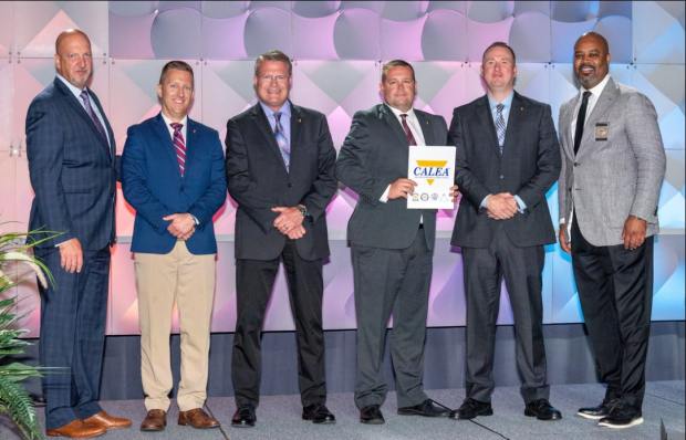 Accepting the CALEA Accreditation at the CALEA Summer Conference in Winston-Salem, N.C. is, from left, W. Craig Hartley, CALEA Executive Director; Valparaiso Police Department Assistant Chief Mark LaMotte; VPD Capt. Brian McDonald; VPD Capt. E. Joe Hall; VPD Chief of Police Andrew McIntyre; and Marlon Lynch, Commissioner (CALEA). (Photo courtesy of Valparaiso Police)