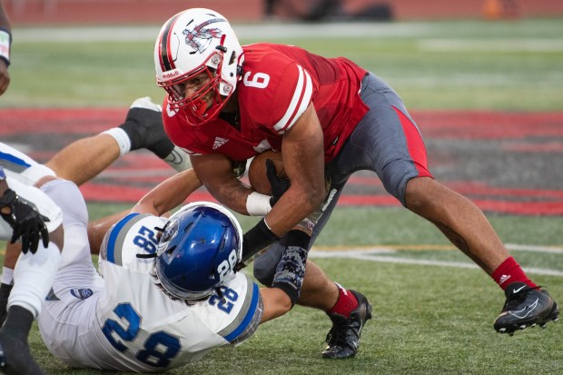 Lake Central's Ryder Fernandez (28) tries to pull down Portage's Terrell Craft during a Duneland Athletic Conference game in Portage on Friday, Sept. 2, 2022. (Kyle Telechan / Post-Tribune)