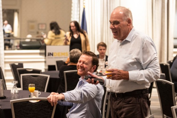 Indiana Democratic Party chair Mike Schmuhl, left, and Jim Wieser from the Lake County Democratic Central Committee talk with fellow delegates at an Indiana Democrats' breakfast, on Monday, Aug. 19, 2024, in Chicago. (Vincent D. Johnson/for the Post-Tribune)