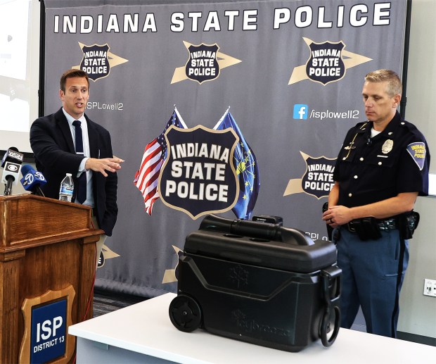 Indiana State Police Detective Chris Eagles (left) and Sgt. Glen Fifield (right) display a portable air conditioner similar to the one used in the transportation of the dogs. The machine was not adequate to cool the truck. The information came out during a combined news conference with Indiana State Police and the Lake County Prosecutor's Office about the conclusion and findings of the year-long investigation into the canine deaths that occurred in Lake Station in 2023.The two agency news conference took place at the Indiana State Police post in Lowell on Tuesday, Aug. 27, 2024. (John Smierciak/Post Tribune)