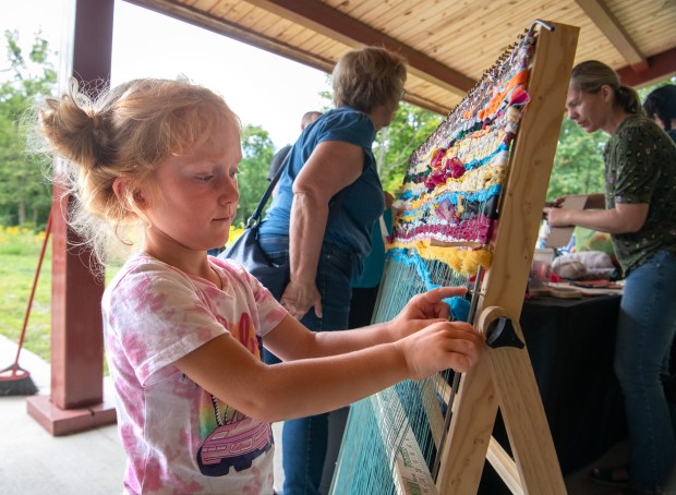 Lily Loop, 4, of New Carlisle, Indiana works on a project during the Nature in the Arts event held at the Meadowbrook Nature Preserve in Valparaiso, Indiana Saturday Aug. 17, 2024. The event was sponsored by The Art Barn School of Art, the Chesterton Art Center and the Shirley Heinze Land Trust. (Andy Lavalley for the Post-Tribune).