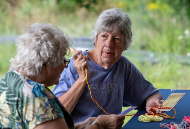 Gloria Potter, right, chats with Diana Poffinbarger while working one of the project's available visitors during the Nature in the Arts event held at the Meadowbrook Nature Preserve in Valparaiso, Indiana Saturday Aug. 17, 2024. The event was sponsored by The Art Barn School of Art, the Chesterton Art Center and the Shirley Heinze Land Trust. (Andy Lavalley for the Post-Tribune).