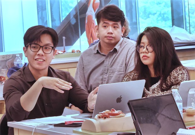 That Huy Au (left) answers a question during a problem-based learning seminar with international medical students at Purdue Northwest in Hammond on Wednesday, Aug. 14, 2024. John Smierciak/for the Post Tribune