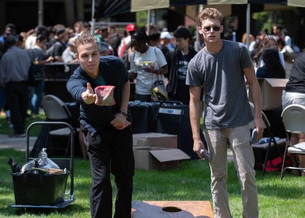 Purdue University Northwest students junior Alexander Dyrkacz of Chicago, left, and junior Nate Kistler of St. John, play bags during the school's annual kick-off rally at the Hammond campus on Thursday, Aug. 22, 2024. (Michael Gard/for the Post-Tribune)