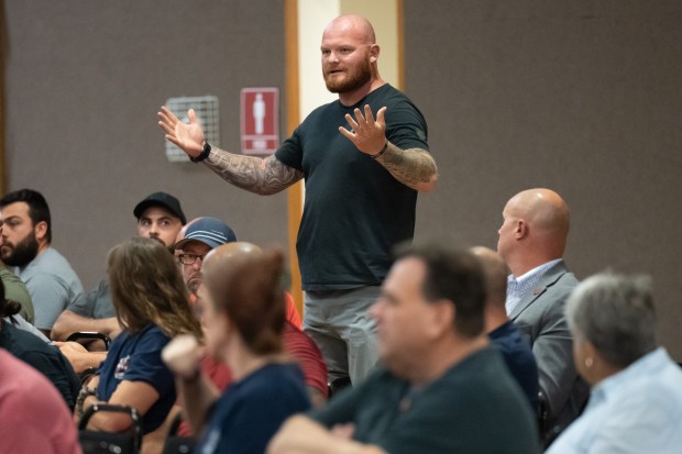 Officer David Wright, with FOP Lodge 145, urges candidates for a clear answer during a public safety forum to talk about the adoption of a public safety tax with Porter County candidates at Woodland Park in Portage on Thursday, Aug. 22, 2024. (Kyle Telechan/for the Post-Tribune)