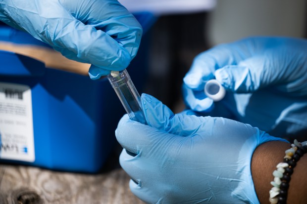 Students mix a testing solution to find the nitrate content in water from Lake Michigan as they participate in Indiana University Northwest's Summer Bridge program for incoming students on Tuesday, Aug. 13, 2024. (Kyle Telechan/for the Post-Tribune)