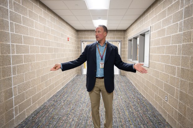 Yost principal Josh Huwig points out the mark where the old and new buildings would have met as he leads a tour of the newly-built Yost Elementary School in Porter on Thursday, Aug. 1, 2024. (Kyle Telechan/for the Post-Tribune)