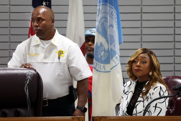 Dolton Deputy Police Chief Lewis Lacey, left, and Mayor Tiffany Henyard before the start of a Dolton Village Board meeting Aug. 5, 2024. (Terrence Antonio James/Chicago Tribune)