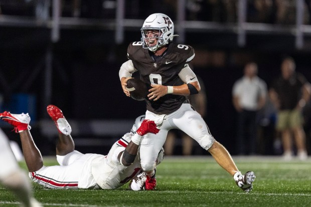 Mount Carmel's Jack Elliott (9) managed to escape from Seth Clarke of the Hun School of Princeton from New Jersey during a nonconference game in Chicago, on Thursday, Aug. 29, 2024. (Vincent D. Johnson/for the Daily Southtown)