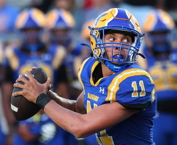 Crete-Monee quarterback Derrin Couch's eyes tell the story as he is chased down by Richards defense during a football game in Crete on Friday, Aug. 30, 2024. (John Smierciak/ Daily Southtown)