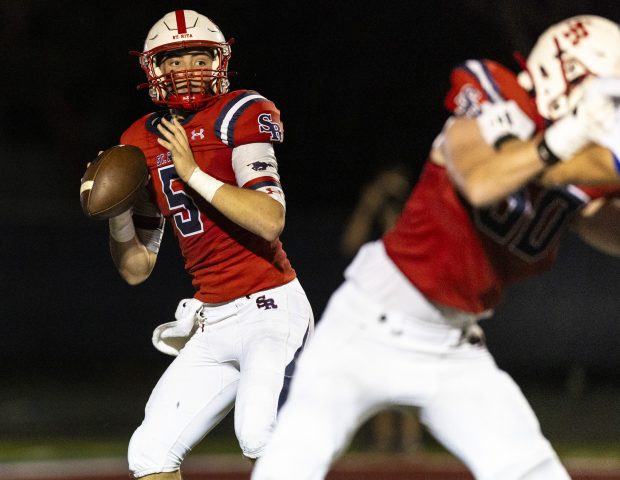 St. Rita's Steven Armbruster (5) looks for an open receiver during a nonconference game against Sandburg in Chicago on Friday, Aug. 30, 2024. (Vincent D. Johnson/ Daily Southtown)