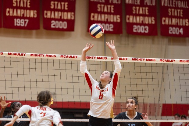 Mother McAuley's Peyton Heatherly (8) sets the ball against Joliet Catholic during a nonconfernce game in Chicago, on Tuesday, Aug.. 27, 2024. (Vincent D. Johnson/for the Daily Southtown)