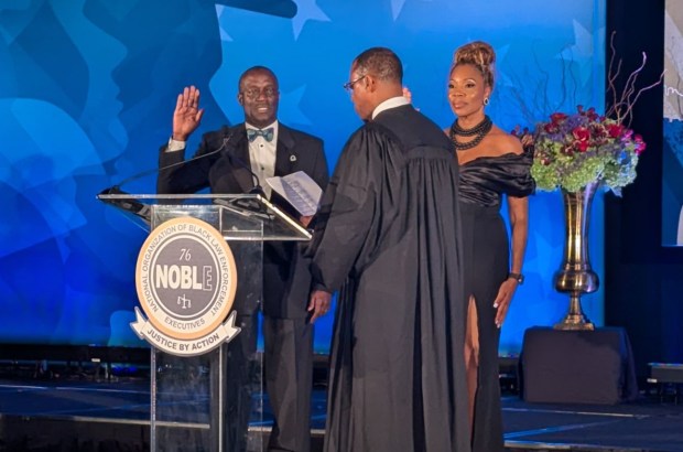 Hazel Crest police Chief Mitchell R. Davis III, left, is sworn in as 2nd vice president of the National Organization of Black Law Enforcement Executives during a ceremony Aug. 13 in New Orleans. (Village of Hazel Crest)