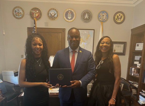 Ani Yarber, left, a senior at Eisenhower high School in Blue Island, and her mother, Newshawn Moore, stand with with U.S. Rep. Jonathan Jackson during a June visit to Washington D.C., where Yarber's artwork was placed in a gallery in the Capitol Building. (School District 218)