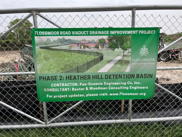 A sign on the construction fence outlines the detention pond project adjacent to Heather Hill Elementary School in Flossmoor. (Brett Johnson/Daily Southtown)