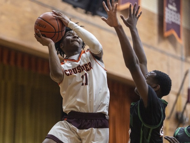 Brother Rice's Ahmad Henderson (11) goes up for the basket as Morgan Park's Randy Walls (20) tries to block his shot during a nonconference game in Chicago on Tuesday, Nov. 29, 2022.