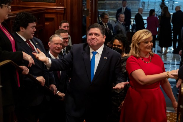 Gov. J.B. Pritzker arrives with first lady M.K. Pritzker to deliver his combined budget and State of the State address to a joint session of the General Assembly at the Illinois State Capitol in Springfield on Feb. 15, 2023. (Brian Cassella/Chicago Tribune)