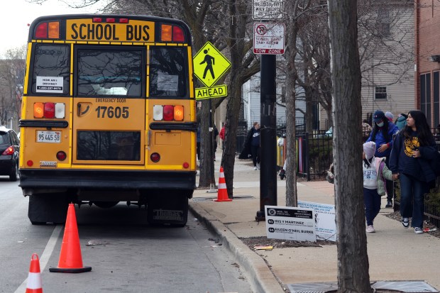 A school bus sits outside Funston Elementary School on W. Armitage Avenue in Chicago at dismissal time on Thursday, March 21, 2024. (Terrence Antonio James/Chicago Tribune)